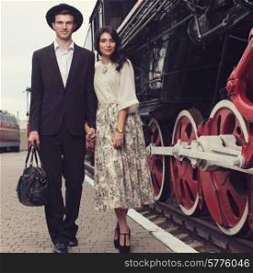 parting of stylish couple of traveler on railway station