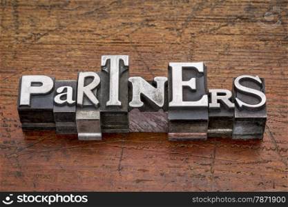 partners word in mixed vintage metal type printing blocks over grunge wood