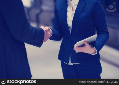 partnership concept with business man and woman hand shake and take agreement in modern office interior