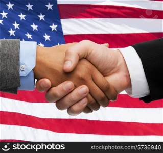 partnership, politics, gesture and people concept - close up of handshake over american national flag background