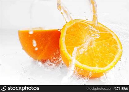 Parts of bright oranges and water splashes