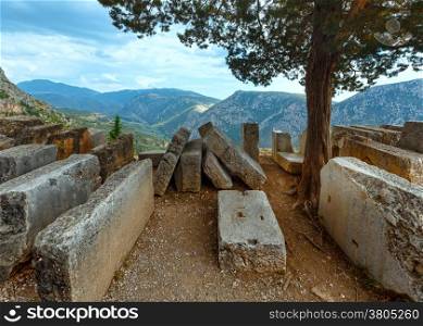 Parts of buildings destroyed the ancient city on mountain slope (Greece)