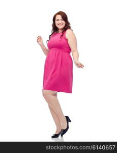 party and people concept - smiling happy young plus size woman posing in pink dress dancing. happy young plus size woman dancing in pink dress