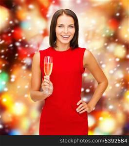 party, drinks, christmas, x-mas concept - smiling woman in red dress with a glass of champagne