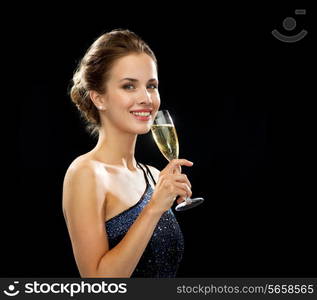 party, drinks, holidays, luxury and celebration concept - smiling woman in evening dress with glass of sparkling wine over black background