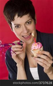 Party Girl Happy Female Holds out Cupcake one Candle Celebrates Birthday