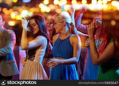 party, holidays, celebration, nightlife and people concept - group of happy friends dancing in night club