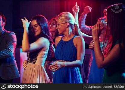 party, holidays, celebration, nightlife and people concept - group of happy friends dancing in night club