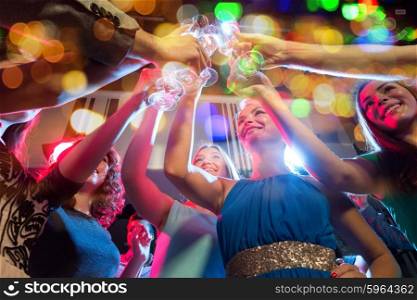 party, holidays, celebration, nightlife and people concept - happy women with clincing glasses of non-alcoholic champagne in club