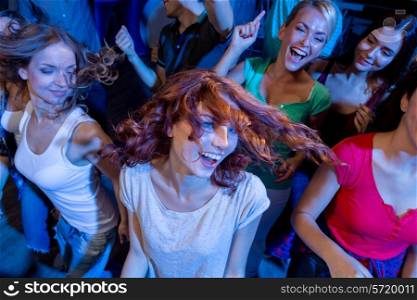 party, holidays, celebration, nightlife and people concept - smiling friends dancing in club