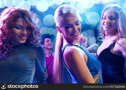 party, holidays, celebration, nightlife and people concept - smiling friends dancing in club