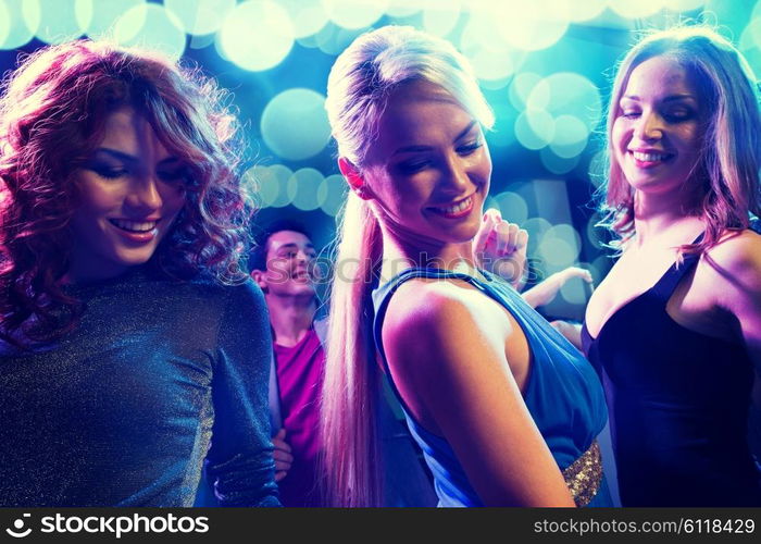 party, holidays, celebration, nightlife and people concept - smiling friends dancing in club