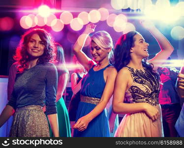 party, holidays, celebration, nightlife and people concept - smiling friends dancing in club