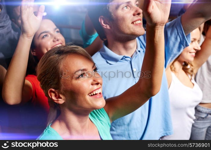 party, holidays, celebration, nightlife and people concept - smiling friends waving hands at concert in club