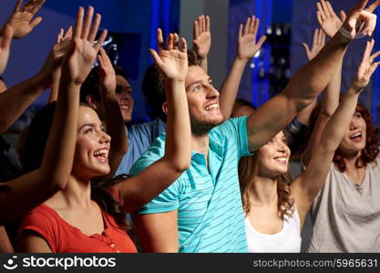 party, holidays, celebration, nightlife and people concept - smiling friends waving hands at concert in club