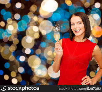 party, holidays, christmas and celebration concept - smiling woman with glass of non-alcoholic sparkling wine over lights background. smiling woman holding glass of sparkling wine