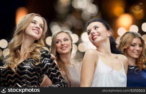 party, holidays, christmas and people concept - happy young women dancing over night lights background. happy young women dancing over night lights