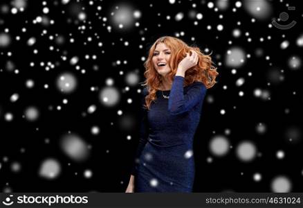 party, holidays, nightlife and people concept - happy young redhead woman dancing at night club disco over black background