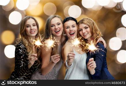party, holidays, nightlife and people concept - happy young women dancing at night club disco over lights background