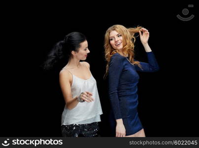 party, holidays, nightlife and people concept - happy young women dancing at night club disco over black background