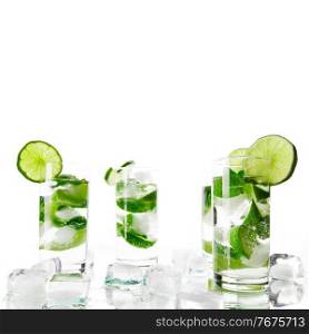 Party mojito cocktails with lime and mint ice cubes isolated on white background. Mojito cocktails and ice