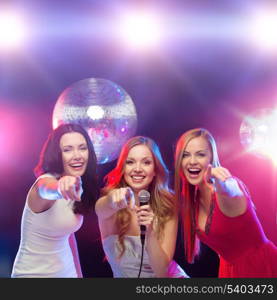 party, new year, celebration, friends, bachelorette party, birthday concept - three women in evening dresses dancing and singing karaoke