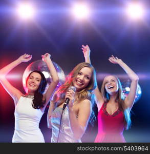 party, new year, celebration, friends, bachelorette party, birthday concept - three women in evening dresses dancing and singing karaoke