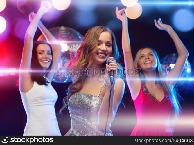 party, new year, celebration, friends, bachelorette party, birthday concept - three women in evening dresses dancing and singing karaoke