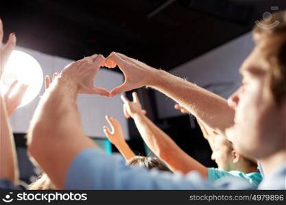 party, nightlife and gesture concept - group of people at concert in club. group of people at concert in club