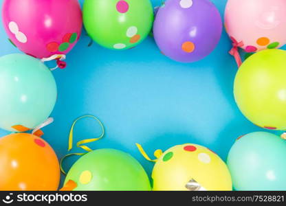 party props, celebration and decoration concept - colorful balloons and confetti on blue background. party balloons and confetti on blue background