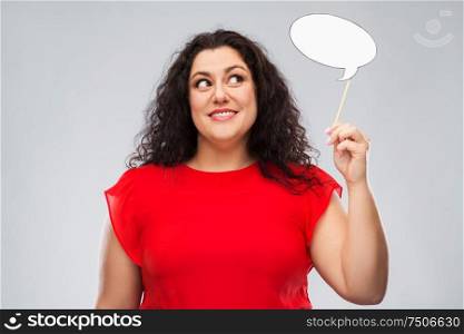 party props, photo booth and communication concept - happy woman in red dress holding big blank speech bubble over grey background. happy woman in red dress holding speech bubble