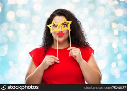 party props, photo booth and people concept - funny woman with star shaped glasses and red lips over festive lights background. funny woman with star shaped glasses and red lips