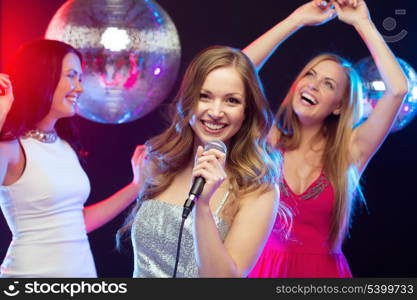 party, &quot;new year&quot;, celebration, friends, bachelorette party, birthday concept - three women in evening dresses dancing and singing karaoke