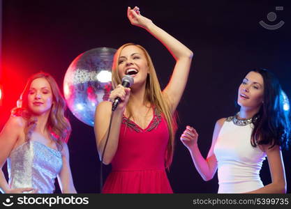 party, &quot;new year&quot;, celebration, friends, bachelorette party, birthday concept - three women in evening dresses dancing and singing karaoke