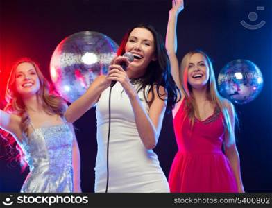 party, &quot;new year&quot;, celebration, friends, bachelorette party, birthday concept - three women in evening dresses dancing and singing karaoke