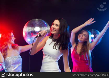 party, &quot;new year&quot;, celebration, friends, bachelorette party, birthday concept - three women in evening dresses dancing and singing karaoke