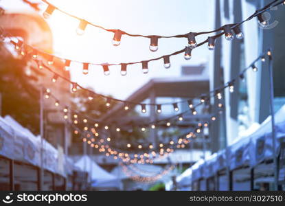 Party string lights hanging in a line on street in Bangkok, Thai. Party string lights hanging in a line on street in Bangkok, Thailand.