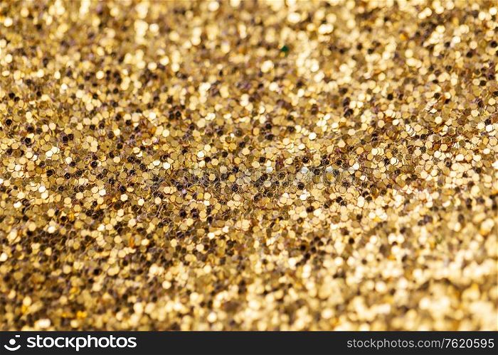 party, texture and holidays concept - golden glitters background. golden glitters background