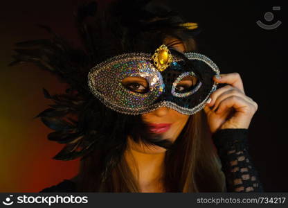 Party time, holidays, people and celebration concept. Woman long hair holds carnival mask close up. Woman holds carnival mask closeup