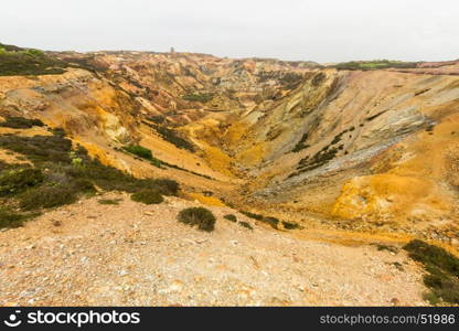 Parys Mountain ex copper mine with derelict windmill in distance. Amlwch, Anglesey, Wales, United Kingdom