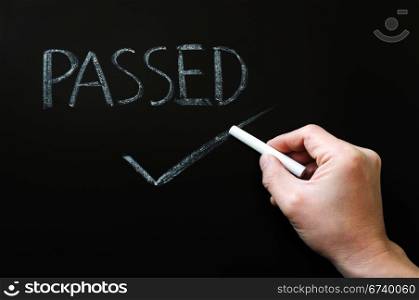 Passed with a hand checking in chalk on a blackboard