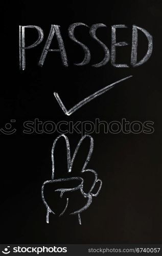 Passed with a victory gesture drawn in chalk on a blackboard