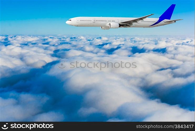 Passenger airplane flying above dramatic clouds