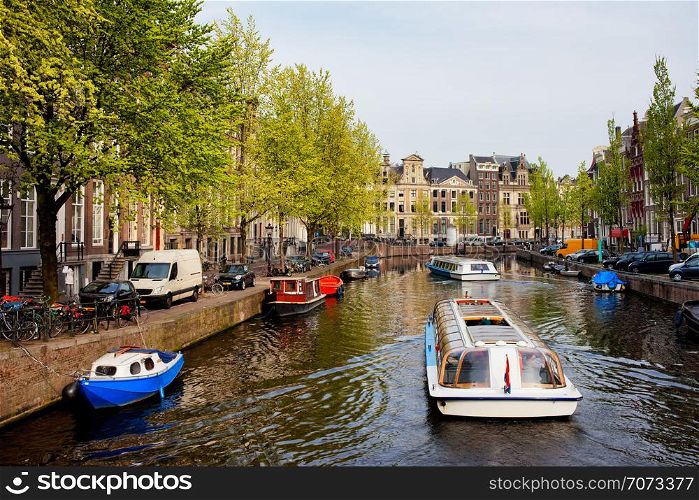 Passenger boats on canal tour in the city of Amsterdam, Holland.