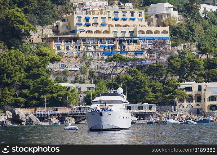 Passenger ship in the sea with buildings in the background, Capri, Campania, Italy