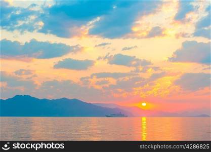 passenger ship on the sea and a beautiful sunrise