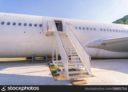 Passenger stair with boarding r&steps. Commercial airplane, aircraft with blue sky background in travel trip and transportation concept. Flying vehicle.