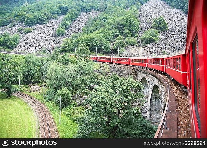 Passenger swiss train in a high mountain railroad