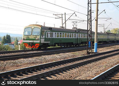 passenger train on electric railway in suburb