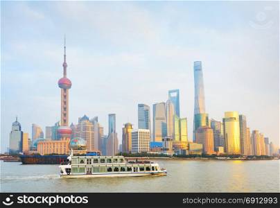 Passengers boat on a river in front of Shanghai Downtown. CHina